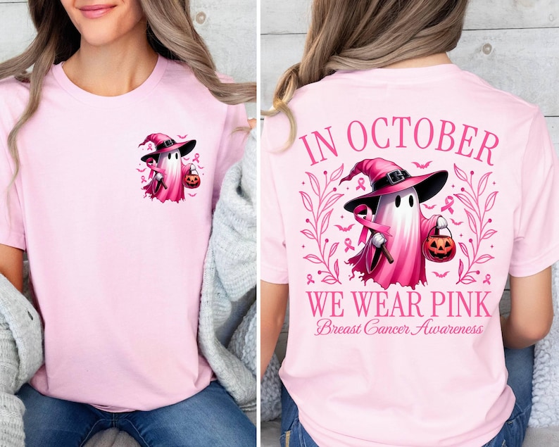 May include: Pink t-shirt featuring a ghost wearing a witch's hat and holding a pumpkin. The back of the shirt reads "In October We Wear Pink Breast Cancer Awareness".