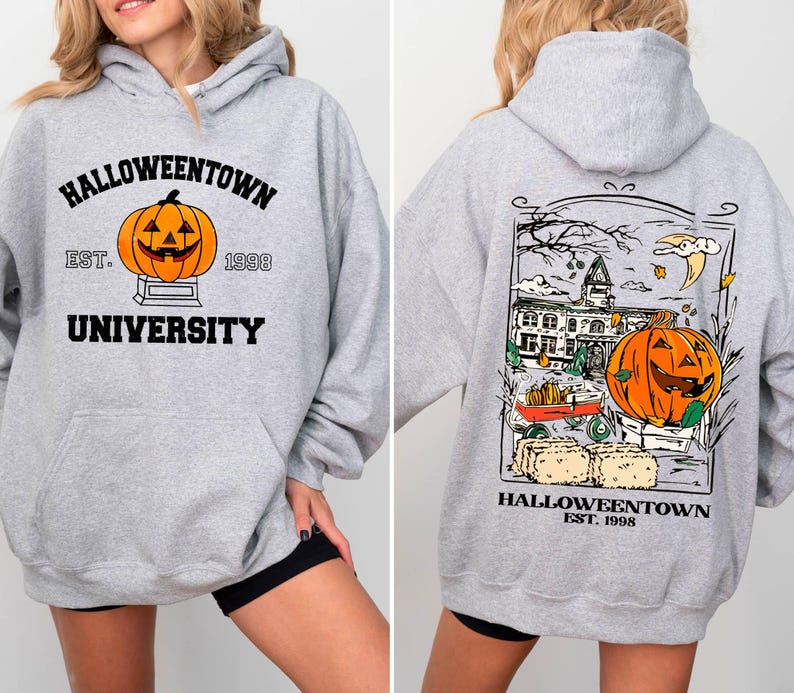 May include: A light gray Halloween-themed hoodie with a front graphic of a jack-o'-lantern and the text "Halloweentown University Est. 1998." The back features a larger graphic with a pumpkin, buildings, and the text "Halloweentown Est. 1998."