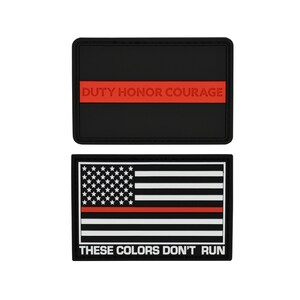 May include: Two black and red embroidered patches. The top patch has the text "DUTY HONOR COURAGE" with a red stripe. The bottom patch has a black and white American flag with a red stripe and the text "THESE COLORS DON'T RUN".