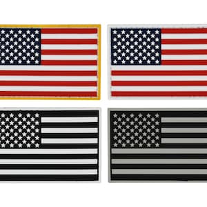 May include: Four embroidered American flag patches. Two patches feature a traditional red, white, and blue design with a yellow border. The other two patches feature a black and white design and a gray and white design.