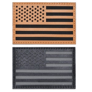 May include: Two American flag patches. One is brown leather with black stitching and the other is black with gray stitching.
