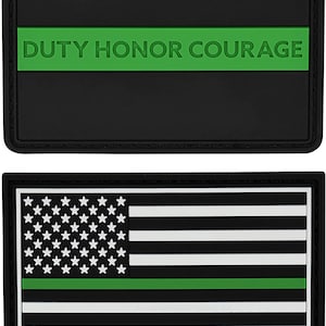 May include: Two black patches with white and green details. The top patch has the text "DUTY HONOR COURAGE" in white letters on a green stripe. The bottom patch has a white American flag with a green stripe across the middle and the text "THESE COLORS DON'T RUN" in white letters at the bottom.