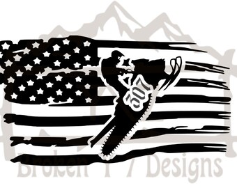 May include: Black and white silhouette of a person riding a snowmobile in front of a distressed American flag. The snowmobile has the number 2017 on the side.
