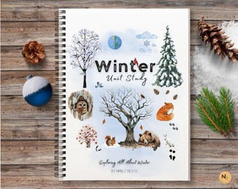 May include: A white notebook with a spiral binding features a winter-themed design. The cover includes illustrations of a snowy forest, animals, and the text "Winter Unit Study Exploring All About Winter by Nimble Nests".