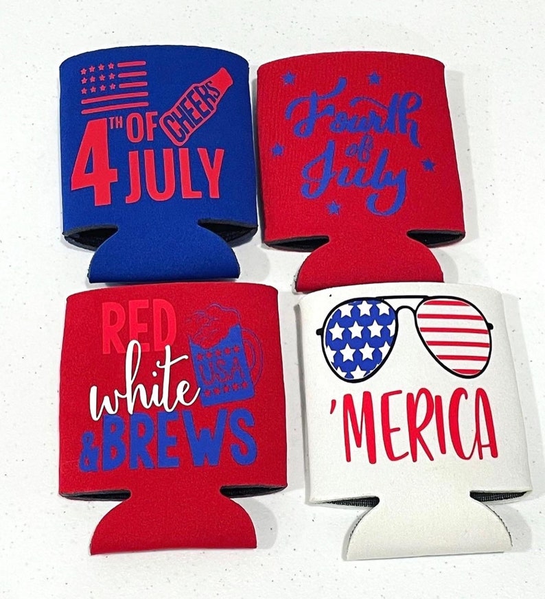May include: Four patriotic can coolers in red, white, and blue. Designs include an American flag, fireworks, and text that reads "4th of July", "Red White & Brews", and "'Merica".