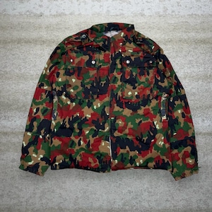 May include: A camouflage jacket in a mix of red, green, black, and brown. The jacket has a zipper closure, multiple pockets, and a button-down collar. The jacket is a medium size.