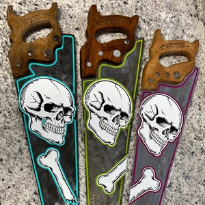 Hand painted skull and bones on vintage saw