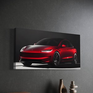 May include: A canvas print featuring a red electric car. The car has a sleek, modern design with black wheels and bright headlights. The print is displayed against a dark gray wall, with decorative items in the foreground.