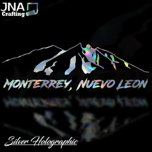 May include: Silver holographic vinyl decal featuring a mountain range silhouette with the text "MONTERREY, NUEVO LEON" underneath.