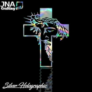 May include: Silver holographic vinyl decal of a stylized image of Jesus Christ's face on a cross. The decal has a rainbow iridescent finish.