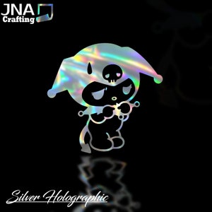 May include: Silver holographic sticker of a cartoon character with a skull on its head. The character has a sad expression and is holding its hands together. The sticker has a reflective, rainbow-like sheen. The text "Silver Holographic" is at the bottom.