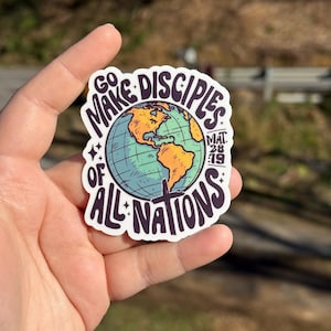 May include: A sticker with the text "GO MAKE DISCIPLES OF ALL NATIONS" in a circular design. The design includes a globe with orange and green continents. The text "MAT 28:19" is also included.