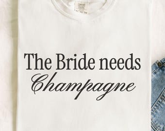 the bride needs champagne, wedding morning outfit, bachelorette party tee, honeymoon sweatshirt, bride gifts