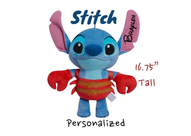 May include: A blue plush Stitch doll, approximately 16.75 inches tall, with large ears and red accents on the arms and waist. The word "Stitch" is written above the doll, and "Personalized" is written below.