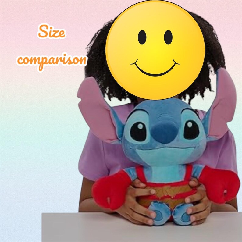 May include: A blue plush toy of a cartoon character with large ears and red arms. The toy is held in front of a person, with a yellow smiley face covering their face. Text on the left says "Size comparison".