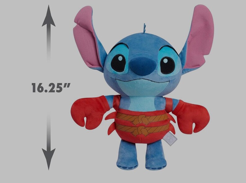 May include: A plush Stitch doll, approximately 16.25 inches tall, in shades of blue, red, and brown. The doll features large ears, a smiling face, and a crab-like outfit. A tag is attached to the doll.