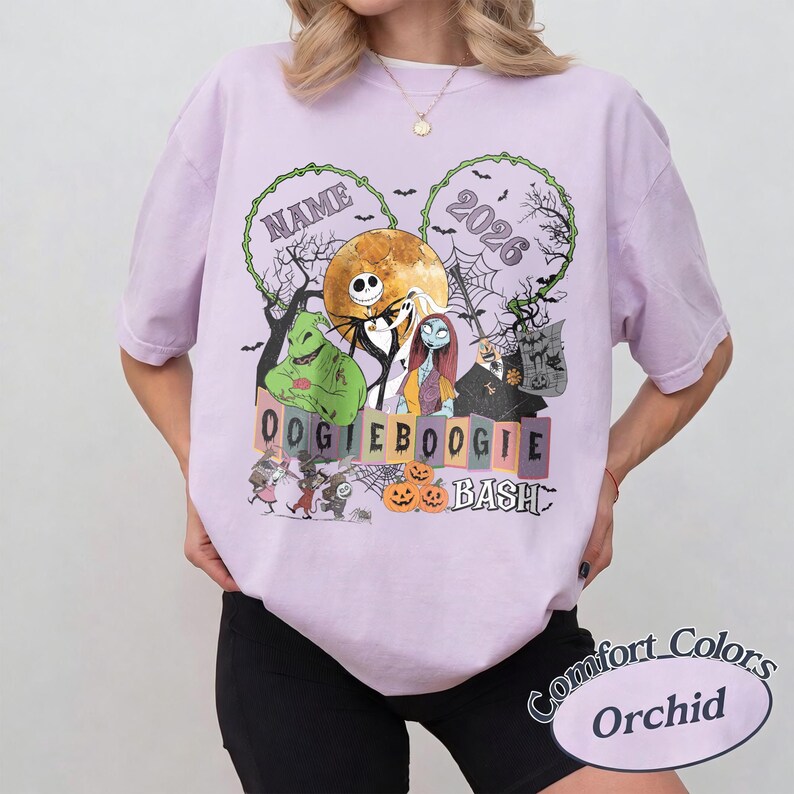 May include: A light purple t-shirt featuring a graphic print of characters from The Nightmare Before Christmas, including Jack Skellington, Sally, and Oogie Boogie. The design includes the text NAME, 2026, OOGIE BOOGIE BASH, pumpkins, bats, and a full moon.