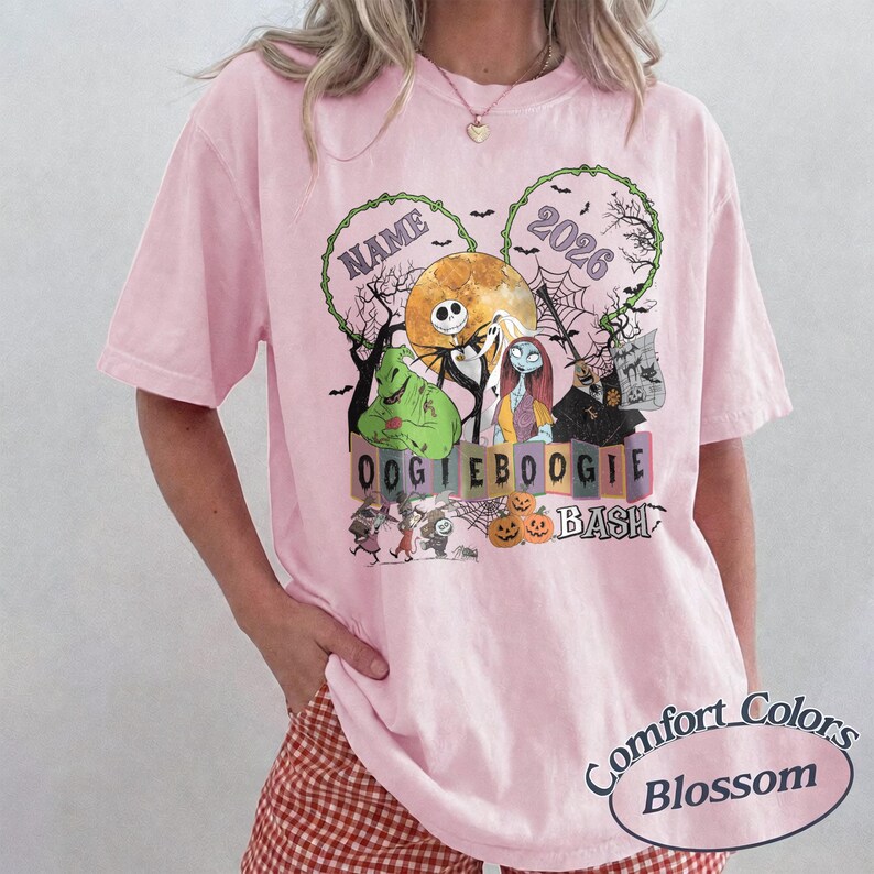 May include: A light pink t-shirt featuring a graphic print of characters from The Nightmare Before Christmas, including Jack Skellington, Sally, and Oogie Boogie, with the text NAME, 2026, and OOGIE BOOGIE BASH, surrounded by pumpkins and bats.