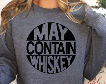 Può includere: Una felpa grigia con una grafica circolare nera che dice "May Contain Whiskey".