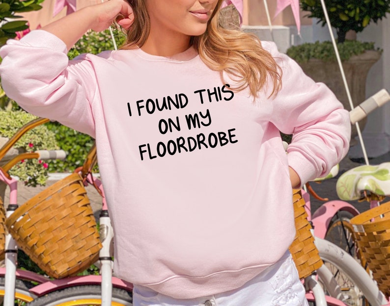May include: Pink sweatshirt with the text "I found this on my floordrobe" printed on the front.