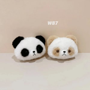 May include: Two plush panda bear head-shaped toys. One is black and white, the other is brown and white. Both have black eyes and a black nose.