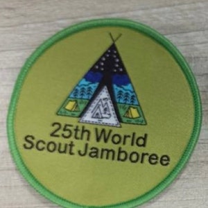 May include: A green and white round patch with a tent design and the text "25th World Scout Jamboree".