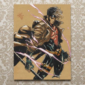 May include: Illustration of the Marvel Comics character Gambit, rendered in a dynamic pose. He wears a brown coat, black suit, and a red top. The artwork features pink energy effects and is signed with the date 1-3-2024.