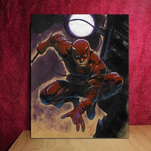 May include: A comic book illustration of Daredevil in a dynamic pose, clad in a red suit with a matching mask. The artwork features a night scene with a full moon and a cityscape silhouette, showcasing the character's agility.