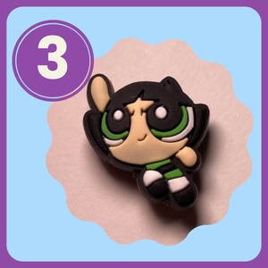 May include: A green, black, and white cartoon character with a green and white striped shirt. The character is from the Powerpuff Girls cartoon.