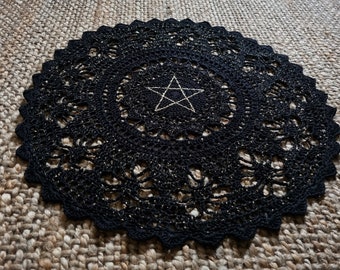 Black and gold crocheted doily with pentagram, statement central piece for an altar