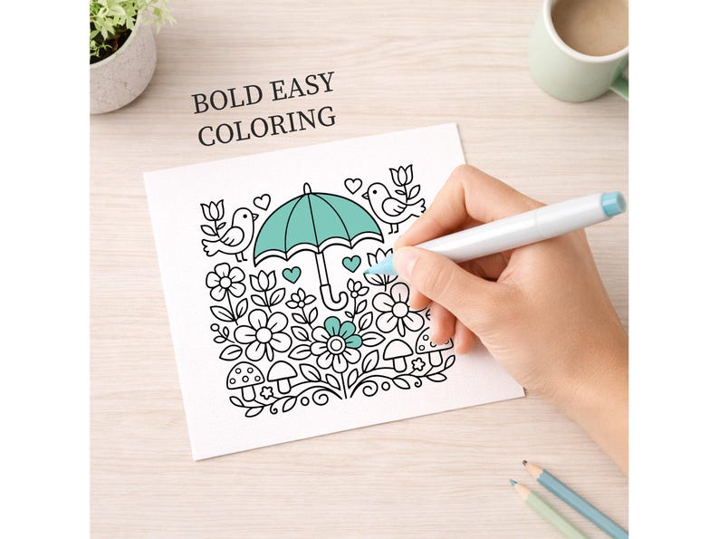 May include: A coloring page with a floral and bird design, featuring an umbrella in the center. The words "BOLD EASY COLORING" are printed at the top. A hand is coloring the image with a blue marker. Two pencils are at the bottom.