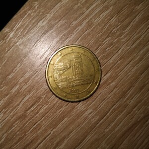 Peut inclure: Une pièce de monnaie de 10 centimes d'euro de couleur dorée avec l'année 2002 imprimée dessus. La pièce présente un motif d'un bâtiment avec une tour.