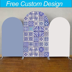 May include: Three freestanding arch-shaped backdrops for a photo booth. The center backdrop features a blue and white patterned design reminiscent of traditional Portuguese tiles. The backdrops on either side are plain, one is light blue and the other is white.