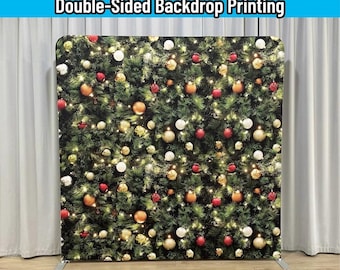 May include: A rectangular backdrop stand with a custom fabric cover featuring a printed Christmas tree design. The print displays green pine branches decorated with red, gold, and white ornaments. Text reads: FRAME+CUSTOM FABRIC COVER INCLUDED.