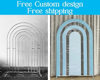 May include: Two different styles of arch backdrops for a wedding or party. The first is a silver metal arch with multiple arches. The second is a blue and white fabric arch backdrop.