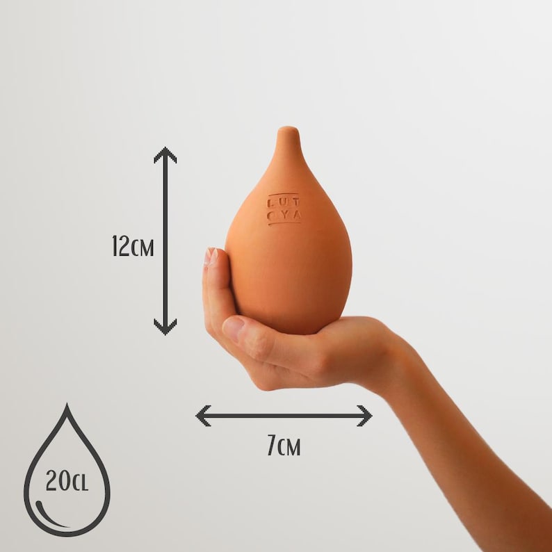 May include: A terracotta-colored ceramic water bottle with a rounded shape and a small spout. The bottle is 12 inches tall and 7 inches wide. It holds 20 fluid ounces of water. The bottle has the text "LUT CYA" embossed on the side.