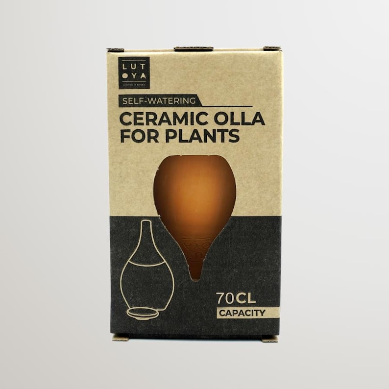 May include: A brown cardboard box with a black and white label. The label says "Self-Watering Ceramic Olla for Plants" and "70CL Capacity". There is a cutout in the box showing a terracotta olla.