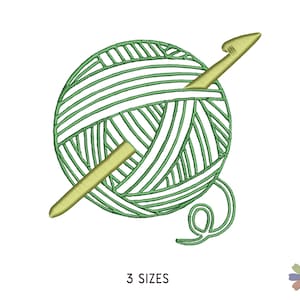 May include: Green yarn ball with a gold crochet hook. The yarn ball has a white center and green stripes. The crochet hook is sticking out of the yarn ball.