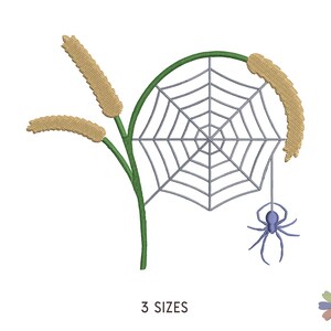 May include: An embroidery design featuring a spider web with a spider hanging from it, surrounded by two stalks of wheat. The web is gray, the spider is blue, and the wheat is yellow.