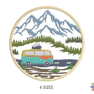 May include: A round embroidered patch featuring a vintage van driving on a road through a forest with mountains in the background. The van is turquoise, orange, and yellow. The mountains are blue and white. The forest is green. The road is grey. The patch is beige.