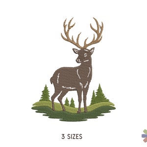 May include: An embroidered design featuring a deer with large antlers, standing on a grassy hill with pine trees. The deer is brown, and the trees are green. The text "3 SIZES" is below the image.
