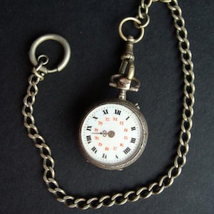 Silver pocket watch with chain
