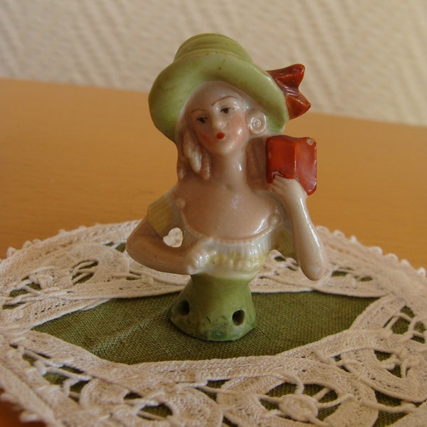 Half porcelain doll with book