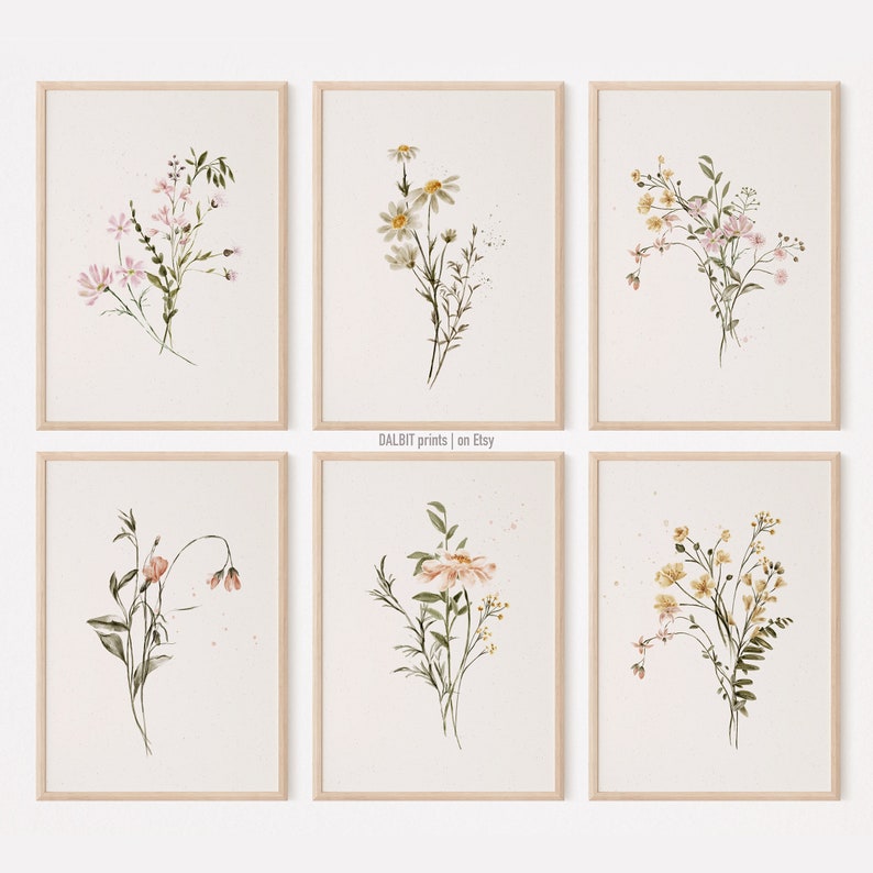 May include: Set of six watercolor floral prints featuring delicate bouquets of pink, white, and yellow flowers with green stems and leaves. The prints are framed in a light wood frame and have a white background.