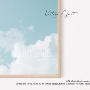 May include: A digital illustration of a light blue sky with white clouds. The text "Vintage Effect" is written in black cursive at the top of the image. The text "DALBIT prints" is written in white cursive at the bottom of the image.