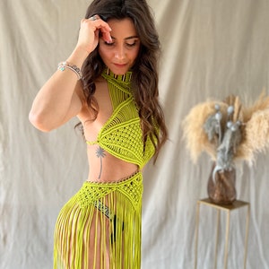 May include: A lime green crochet top with a halter neckline and fringe detailing. The top is made of a lightweight, breathable material and features a geometric pattern.