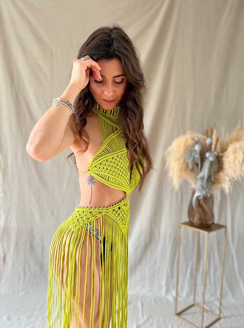 May include: A lime green crochet top with a halter neckline and fringe detailing. The top is made of a lightweight, breathable material and features a geometric pattern.