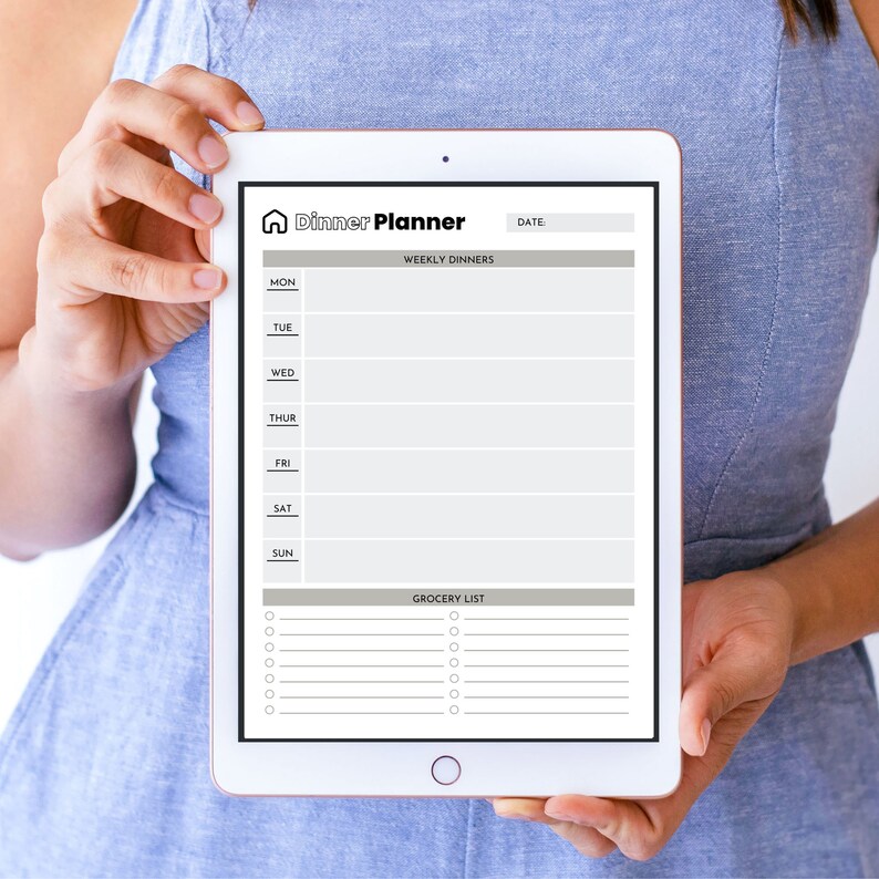 May include: A white tablet with a gray and white weekly dinner planner and grocery list. The planner has a house icon and the text "Dinner Planner". The grocery list has checkboxes.
