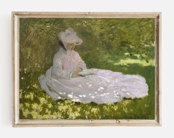 May include: A painting of a woman in a pink dress and white hat sitting in a field of flowers. She is reading a book and the sun is shining on her.