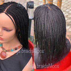 May include: A black wig with small braids, styled in a long, straight bob. The wig is made with human hair and is designed to be worn by anyone.